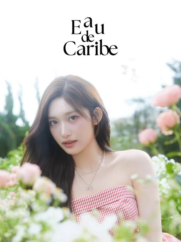 Outdoor campaign portrait in a pink gingham top among roses.
