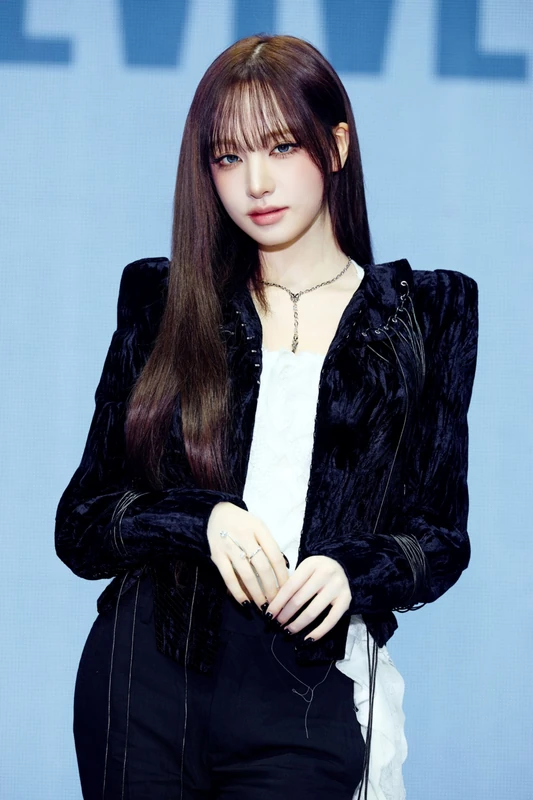 Liz wearing a black velvet jacket over a white top
