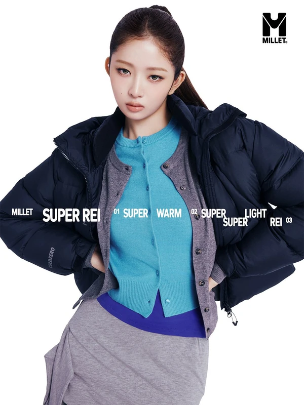 Millet SUPER REI campaign portrait in a dark navy puffer, turquoise cardigan and grey knitwear.