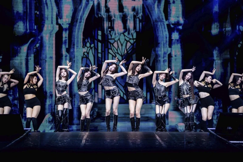A wide stage photograph with performers and dancers in a coordinated formation