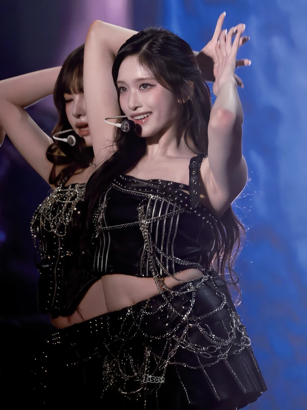 Concert portrait in a black stage outfit with silver chain details