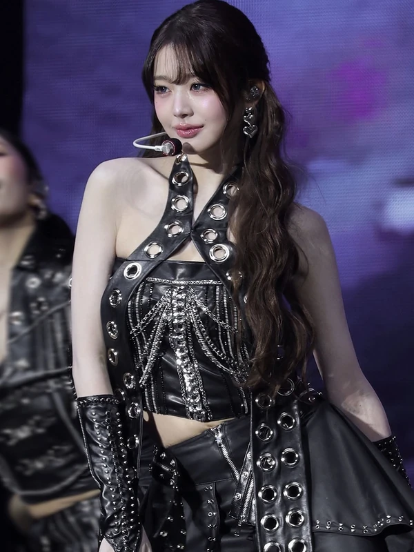 Concert portrait in a black halter-neck stage outfit with silver rings