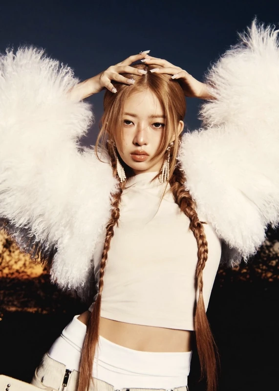 Rei in a white feathered outfit with two long braids