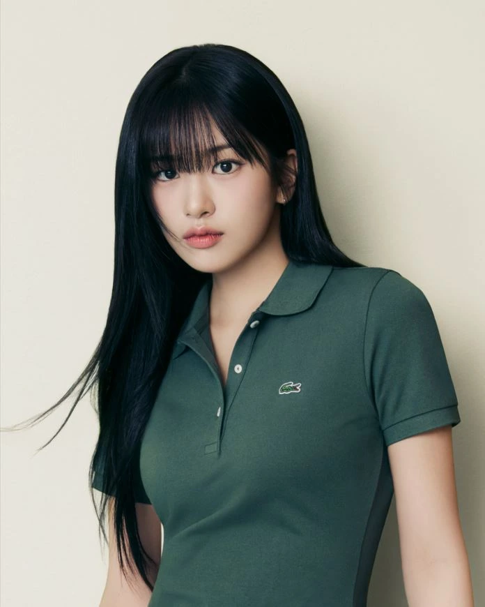 Yujin in a green Lacoste polo dress against a neutral studio background