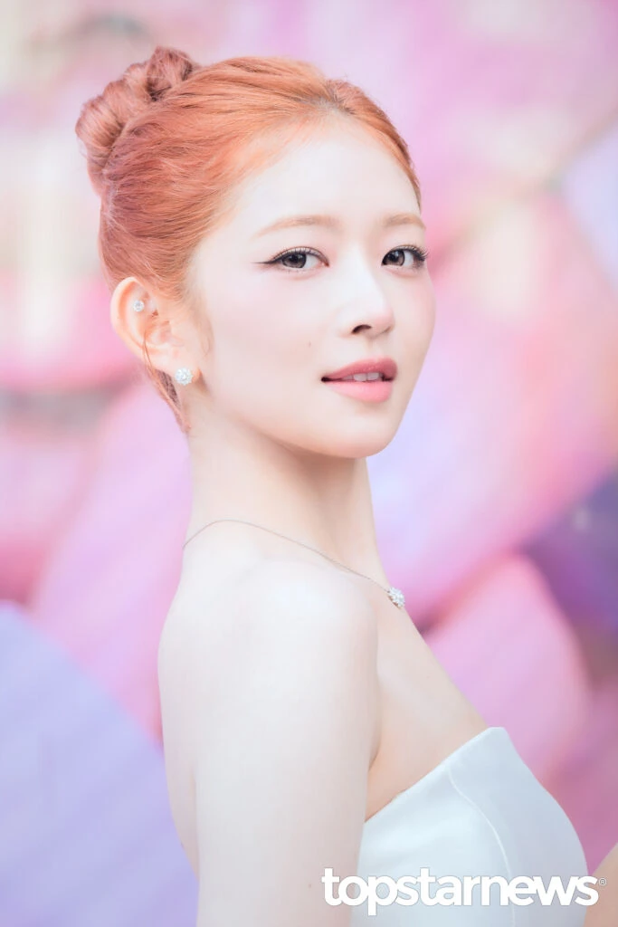 Rei wearing a pale blue dress at the LUNA opening