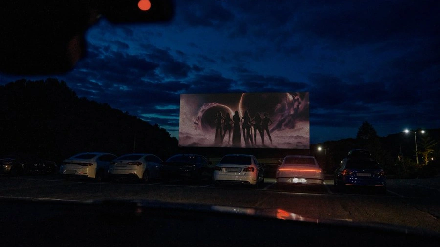 Outdoor cinema screen displaying six hero silhouettes