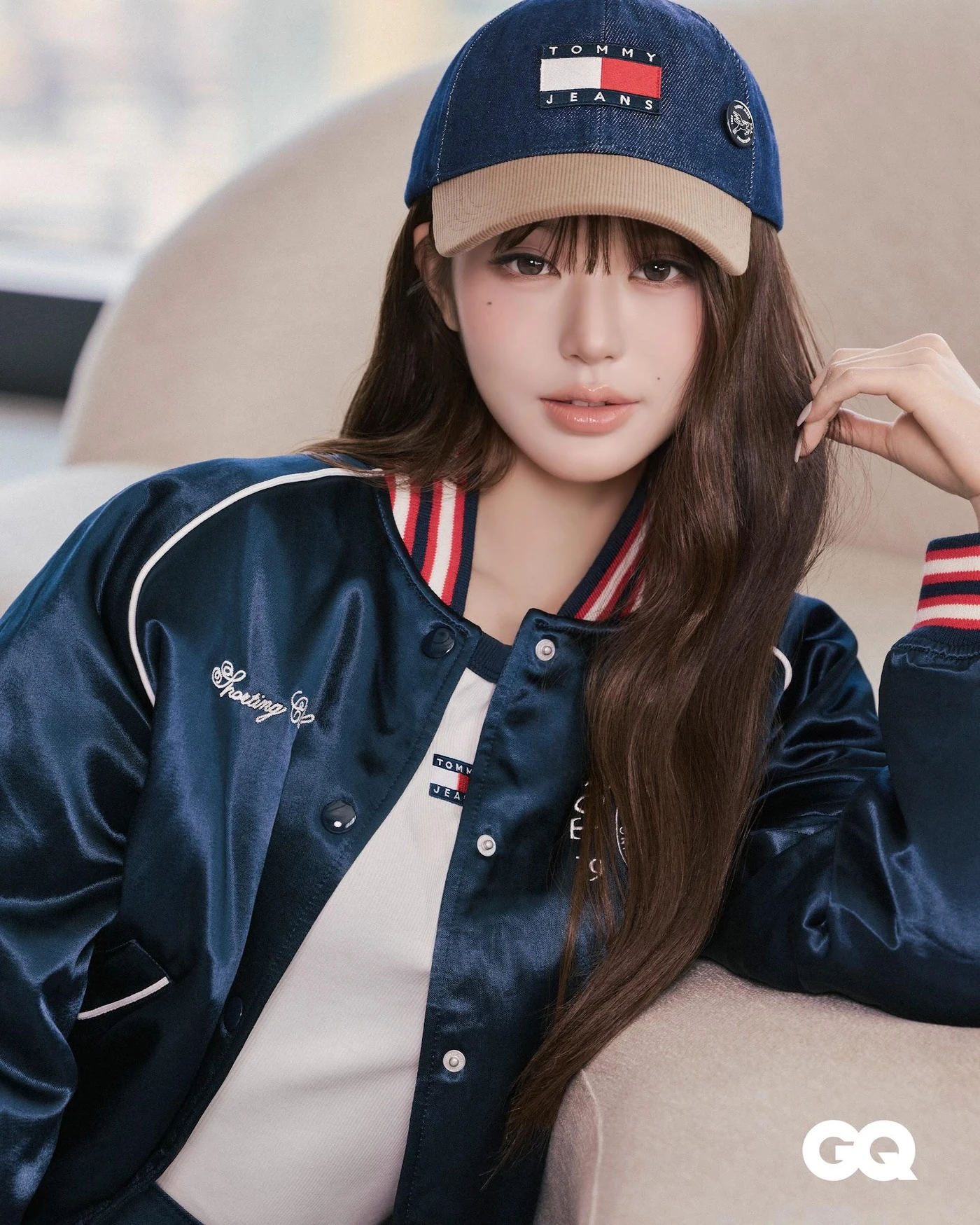 Wonyoung wearing a navy Tommy Jeans cap and varsity jacket
