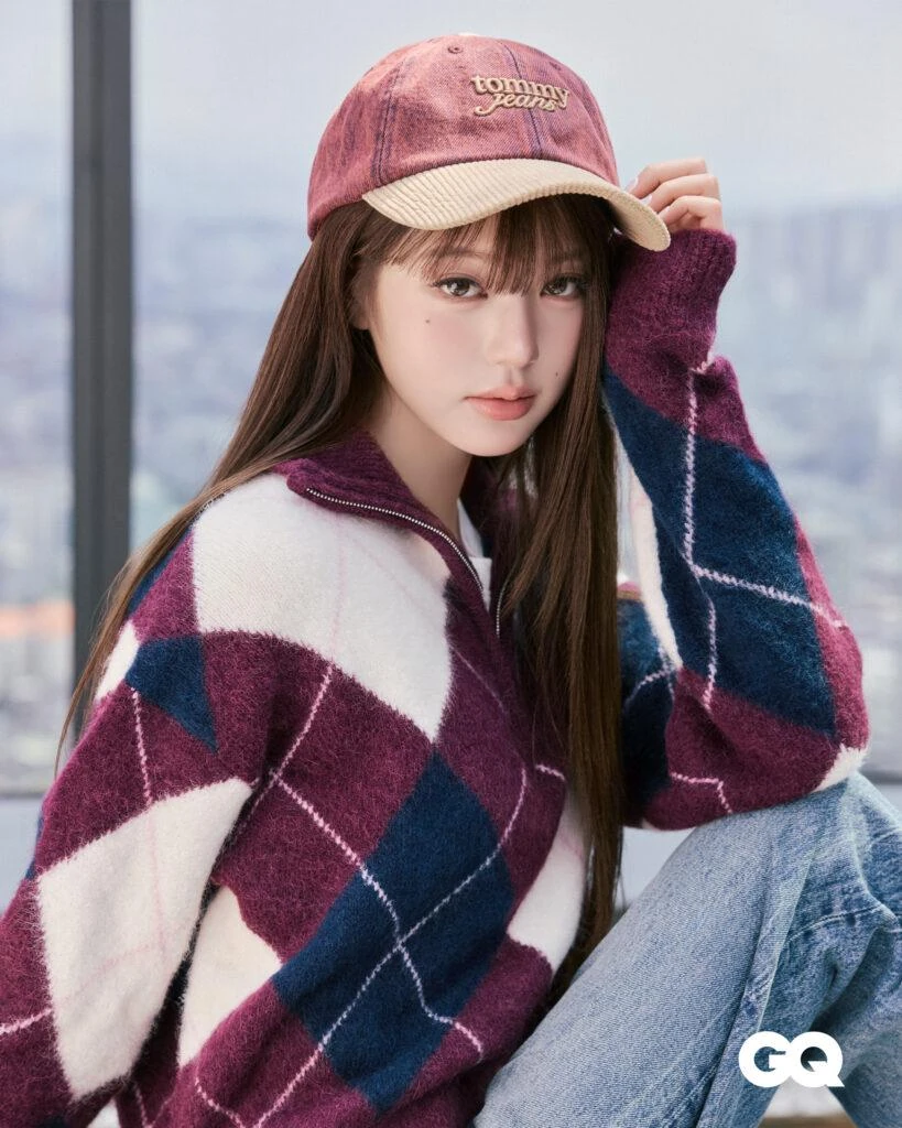Wonyoung in a burgundy Tommy Jeans cap and argyle quarter-zip sweater