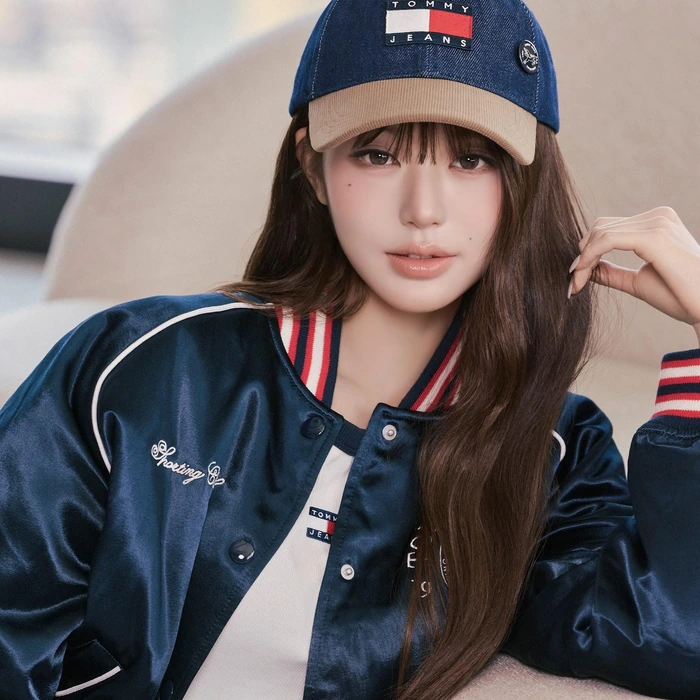 Wonyoung wearing a navy Tommy Jeans cap and varsity jacket