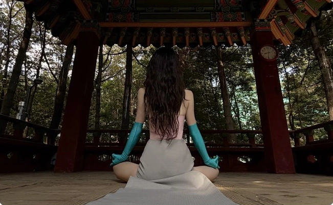 A hero-costumed figure sitting in a traditional park pavilion