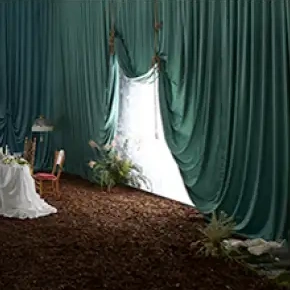 Green-curtained setting in the official preview of IVE’s The Resonance