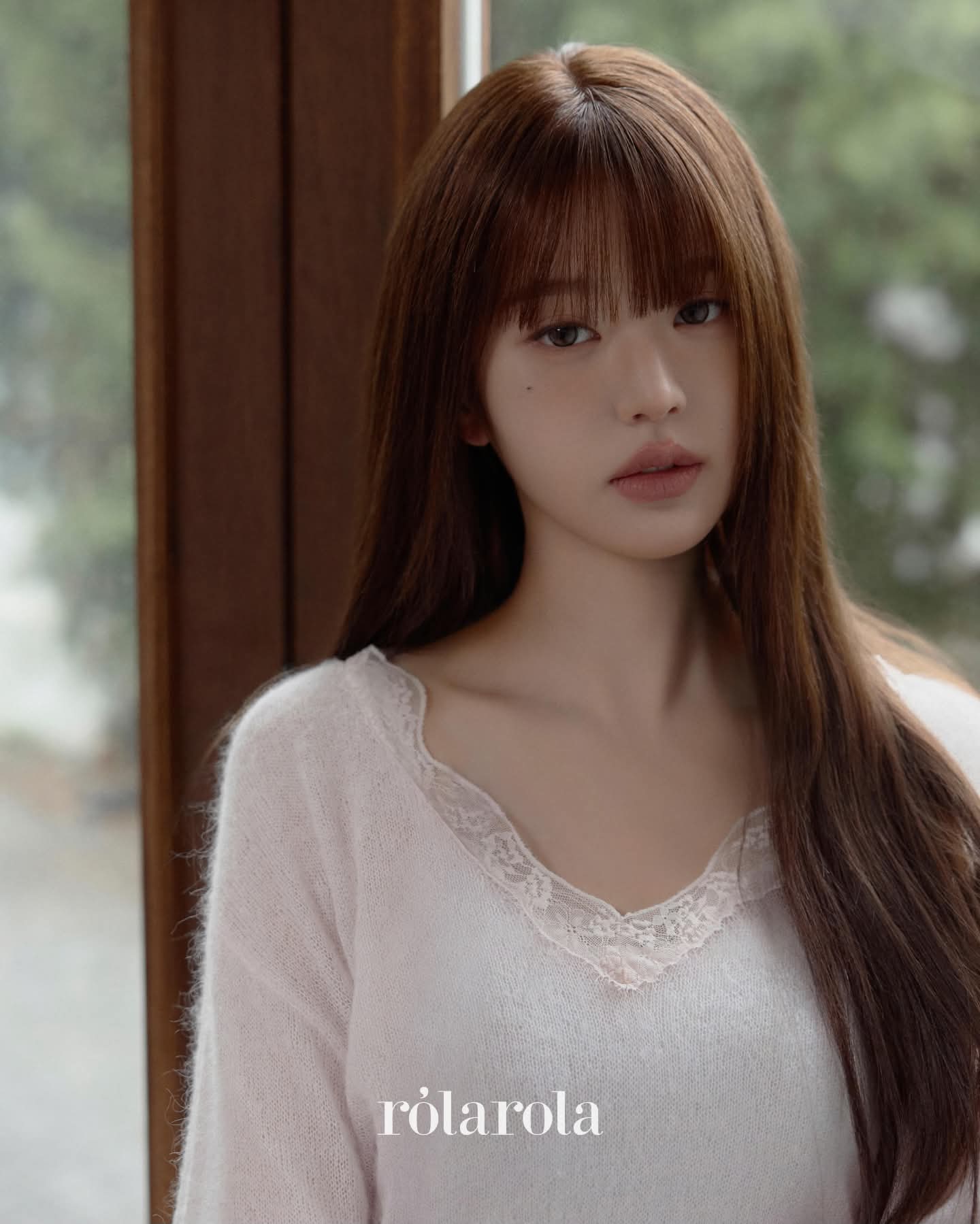 Pale pink knitwear with a lace-trimmed neckline.